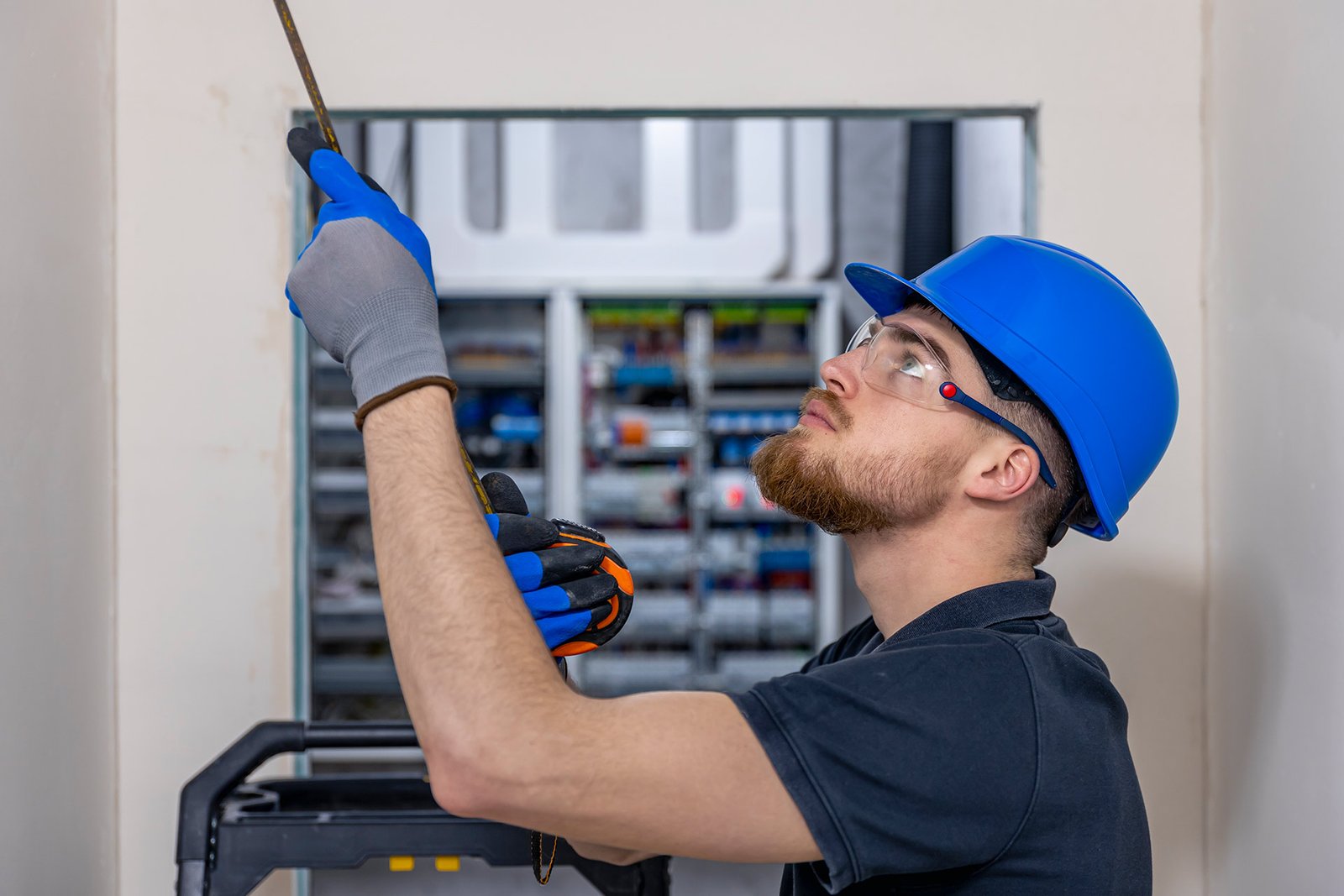 Technician inspecting an electromechanical control panel